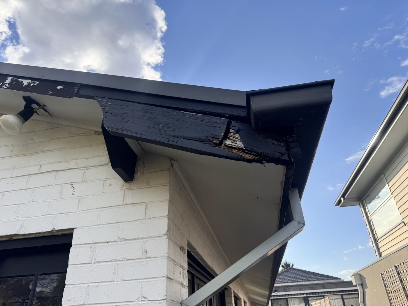Before: rotted and splintered fascia at the roof corner