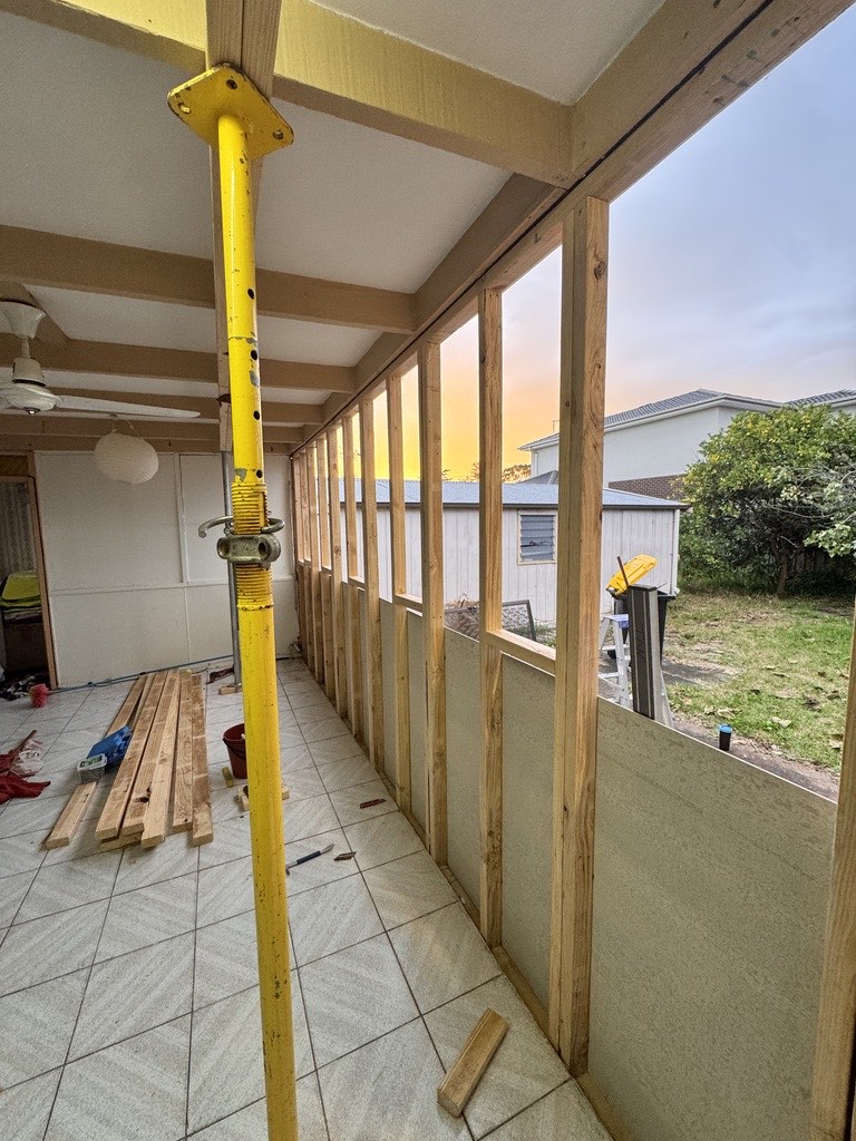 New stud wall framed into an enclosed verandah, propped and squared, Melbourne