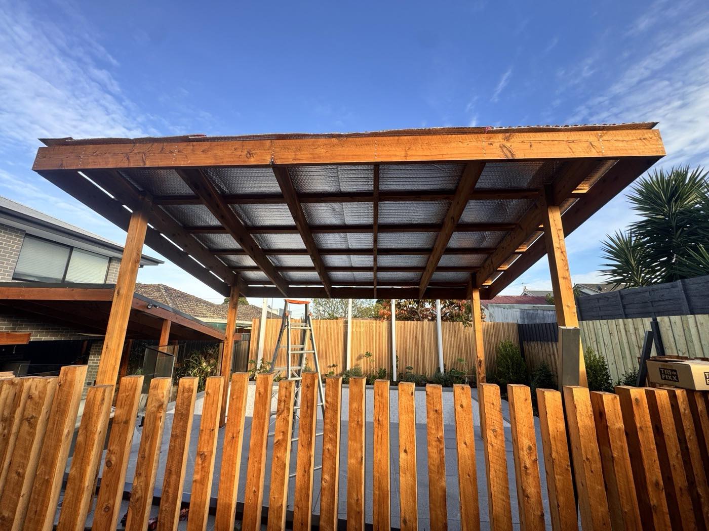 Hardwood pergola with insulated roof over a paved courtyard, Melbourne